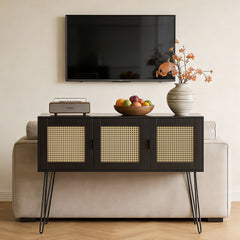 Modern living room with a black console table, TV, and decorative items.