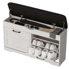White shoe storage bench with open lid showing shoes, an umbrella, and other items.
