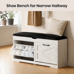 White shoe bench with black cushion in a narrow hallway setting.